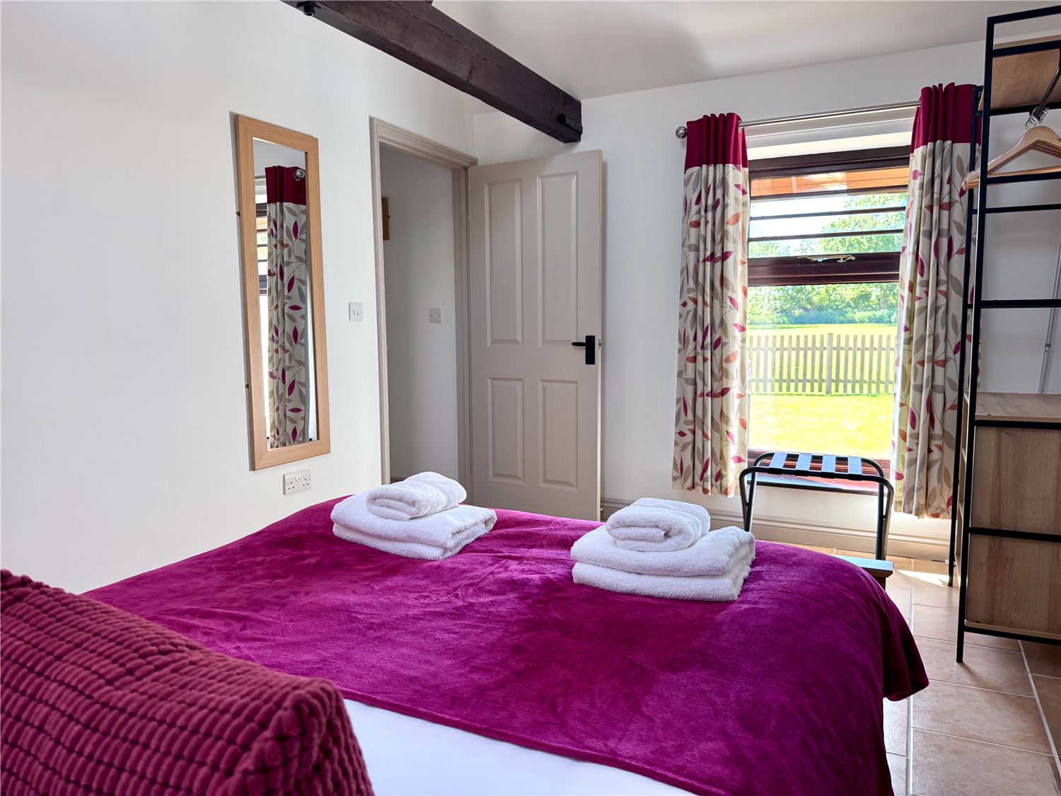 Kingsize bed with garden views at dog friendly Norfolk Broads holiday cottage sleeps 4