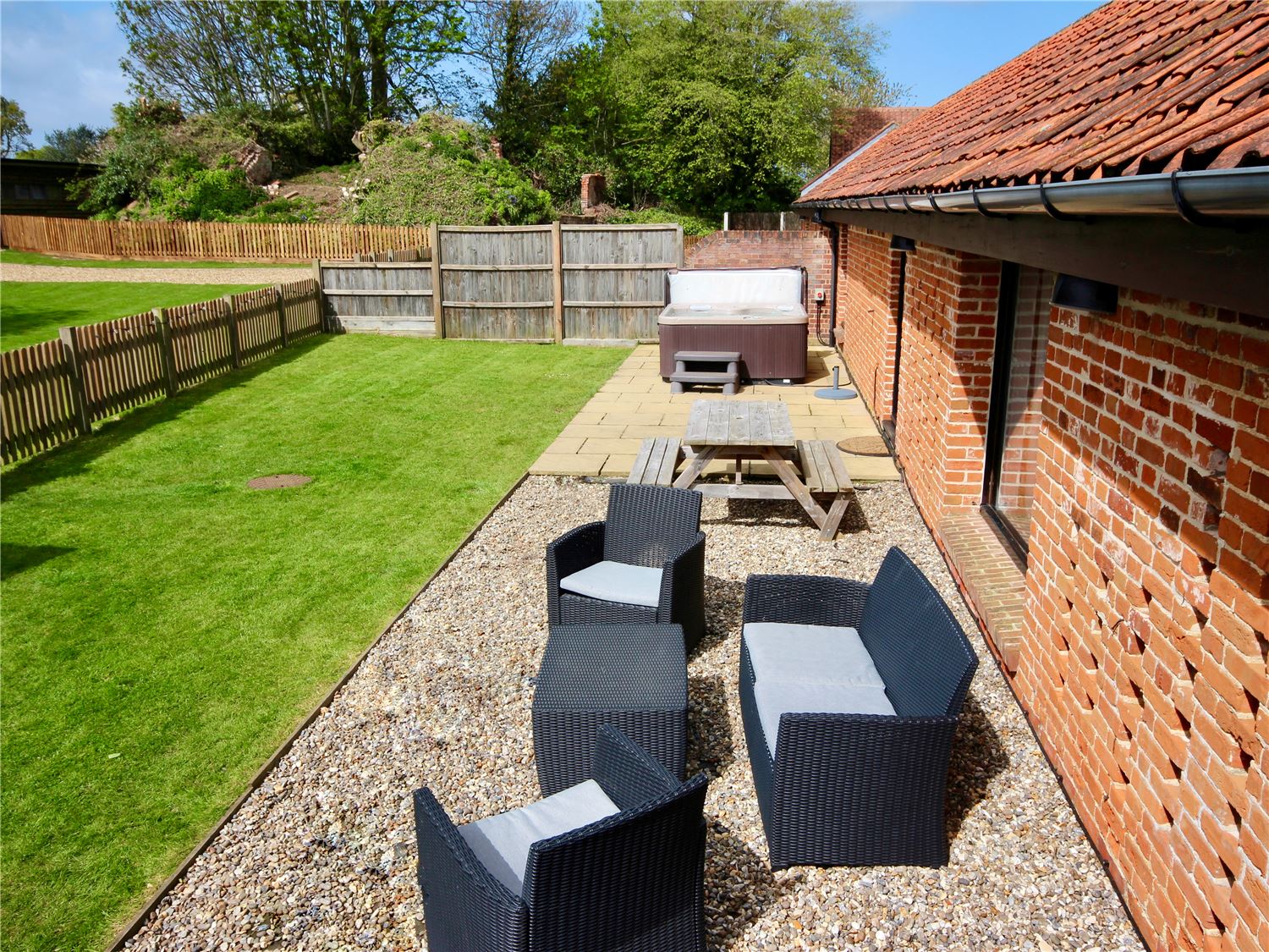 Fully enclosed dog friendly garden with hot tub at Norfolk Broads holiday cottage