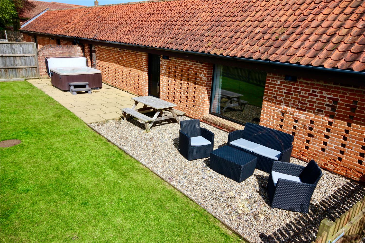 Fully enclosed dog friendly garden with hot tub at Norfolk Broads holiday cottage