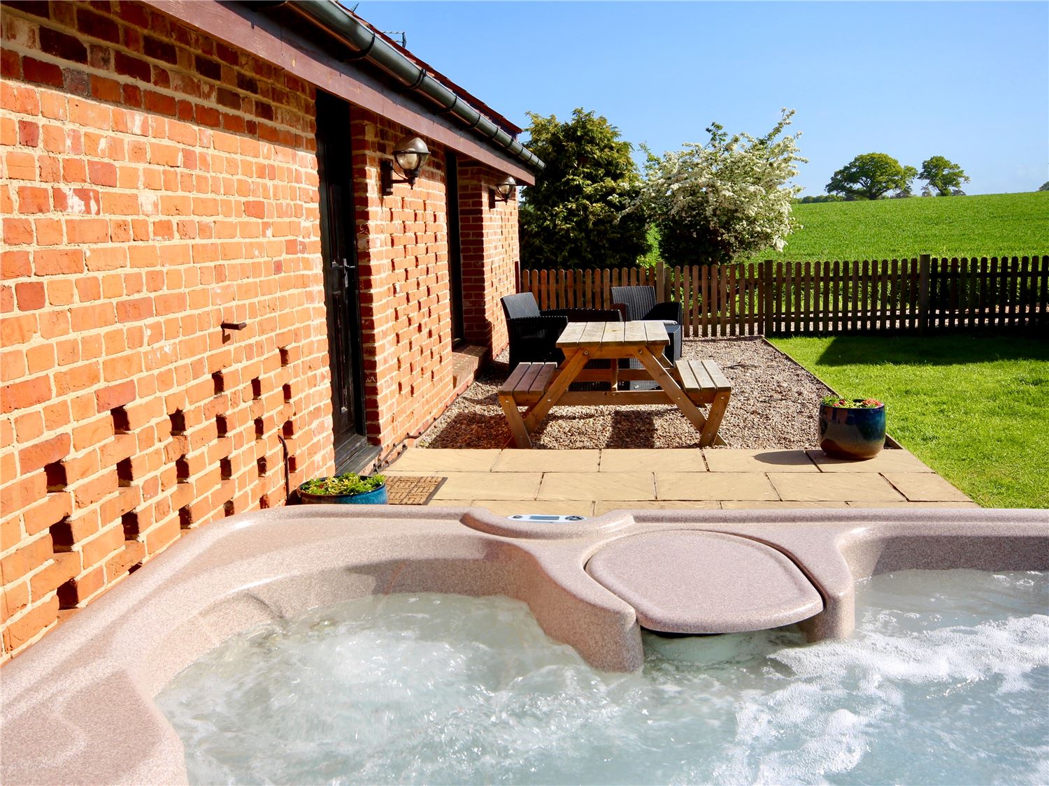 Private hot tub with countryside views at dog friendly Norfolk Broads holiday home sleeping 4