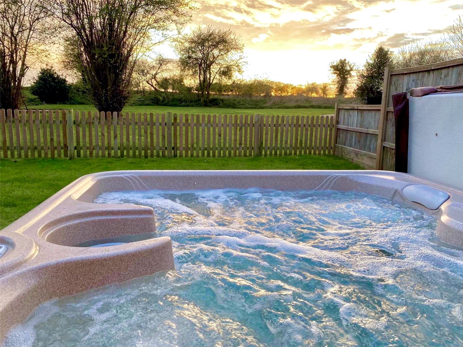 Private hot tub with sunset views at Norfolk holiday home