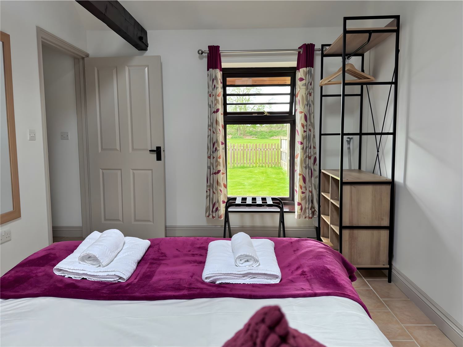 Kingsize bed with garden views at dog friendly Norfolk Broads holiday cottage sleeps 4