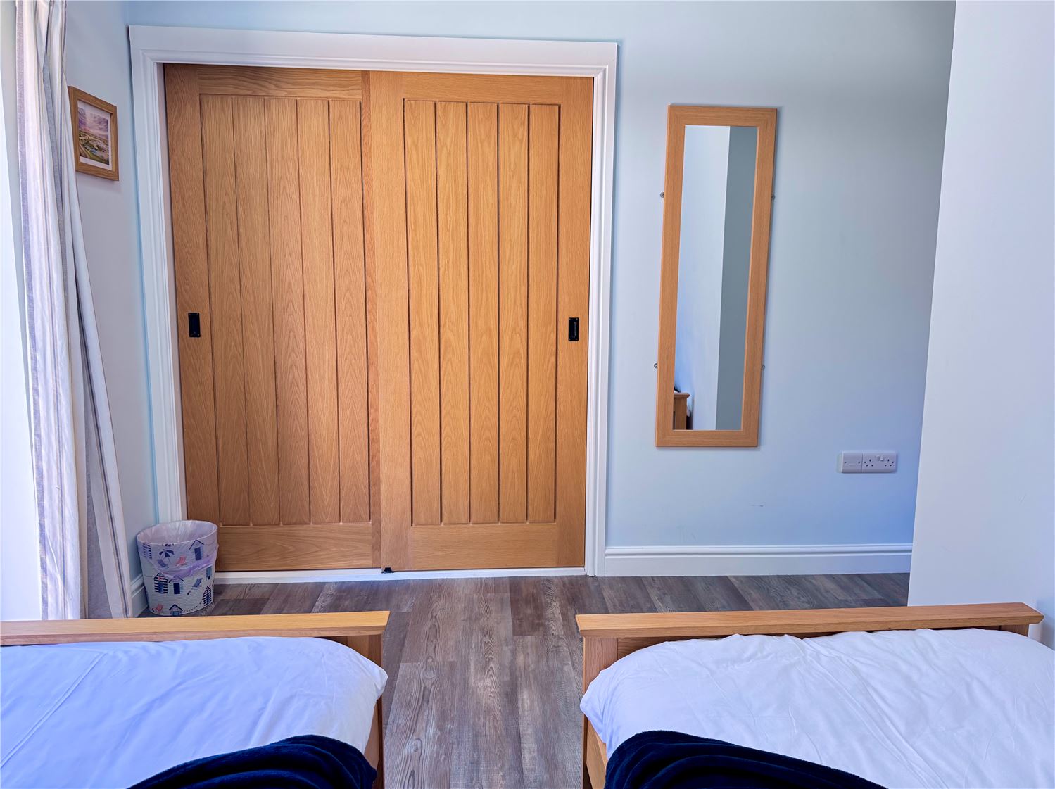 Twin bedroom with fitted wardrobes at dog-friendly Norfolk Broads holiday cottage sleeps 6